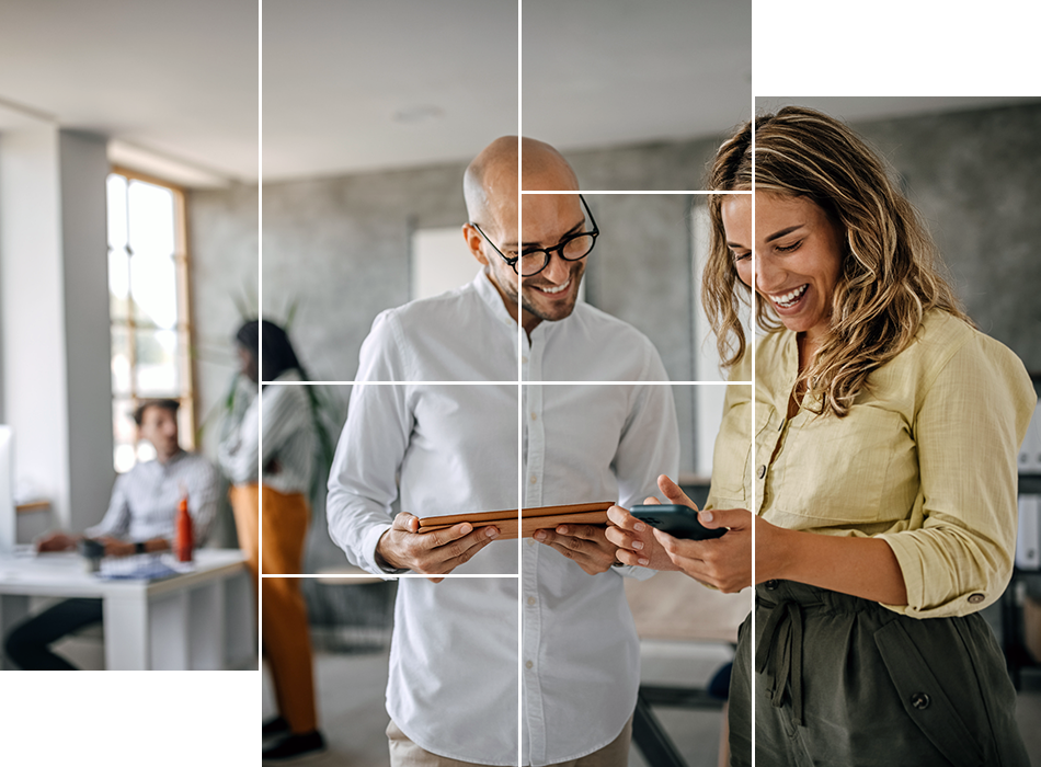 A man and woman, engaged in back office service, intently gaze at a phone screen together.