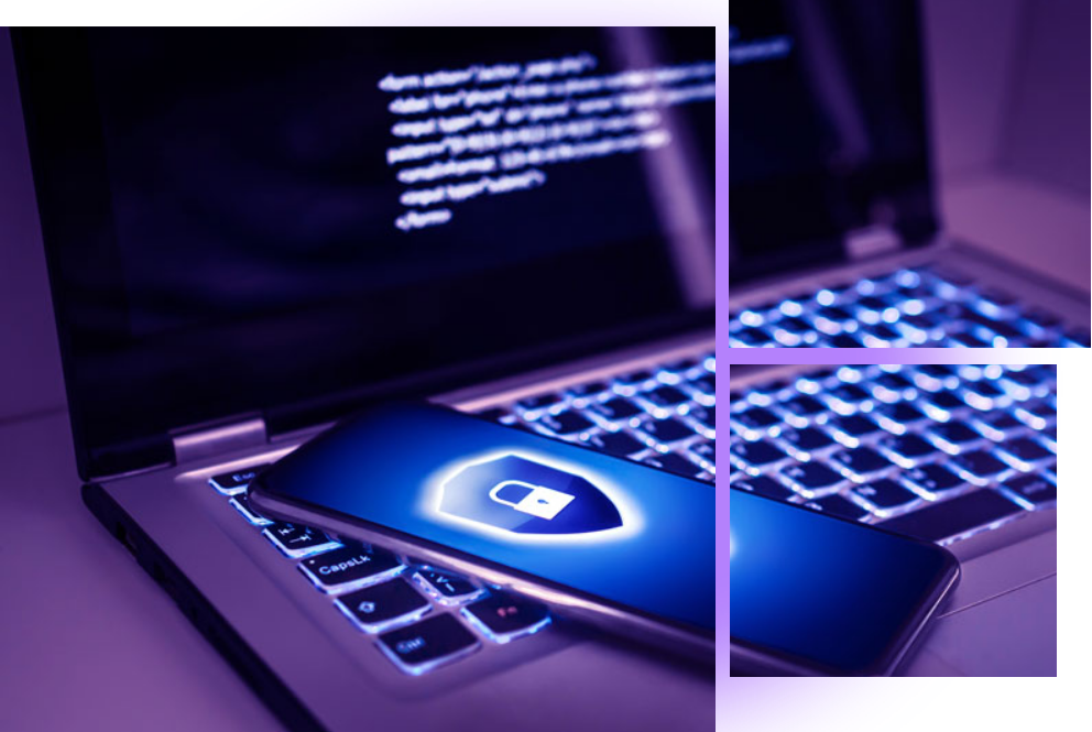 A laptop with a keyboard and a phone on it, representing security quality assurance.
