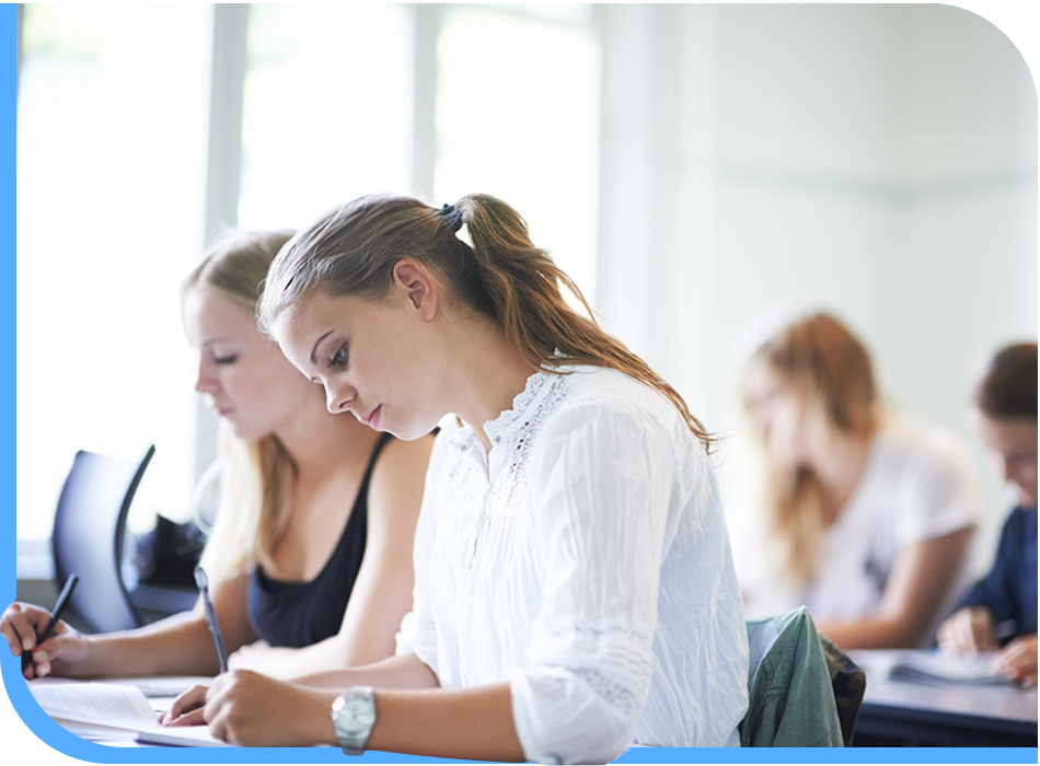 A classroom filled with students immersed in online English learning, diligently writing as part of their educational journey.