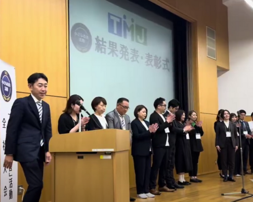 Kaizen continuous improvement highlighted as professionals gather during an awards ceremony.