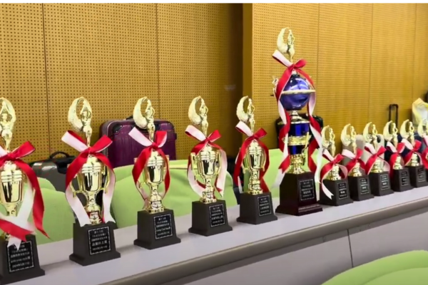 Trophies lined up to honor outstanding Kaizen process improvement achievements in BPO.