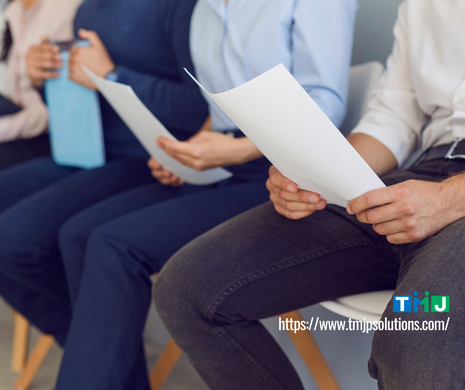 Row of professionals seated with documents in hand, symbolizing preparation and mastery of six fundamental skills for corporate success.