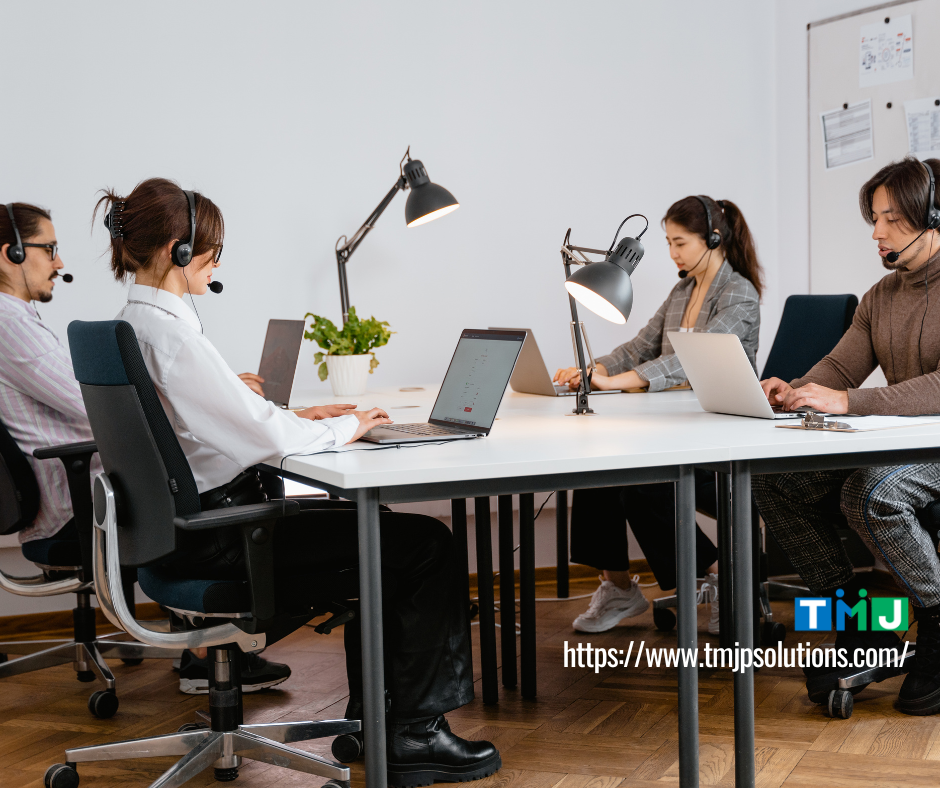 Office team at desks with laptops and headsets, symbolizing personalized customer support as a driver of SME success.