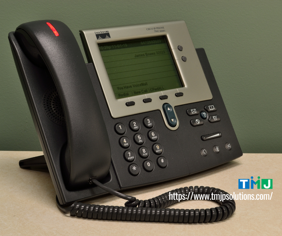 IP office phone with digital display showing voicemail notification, symbolizing outbound sales success from warm calls to closed deals.