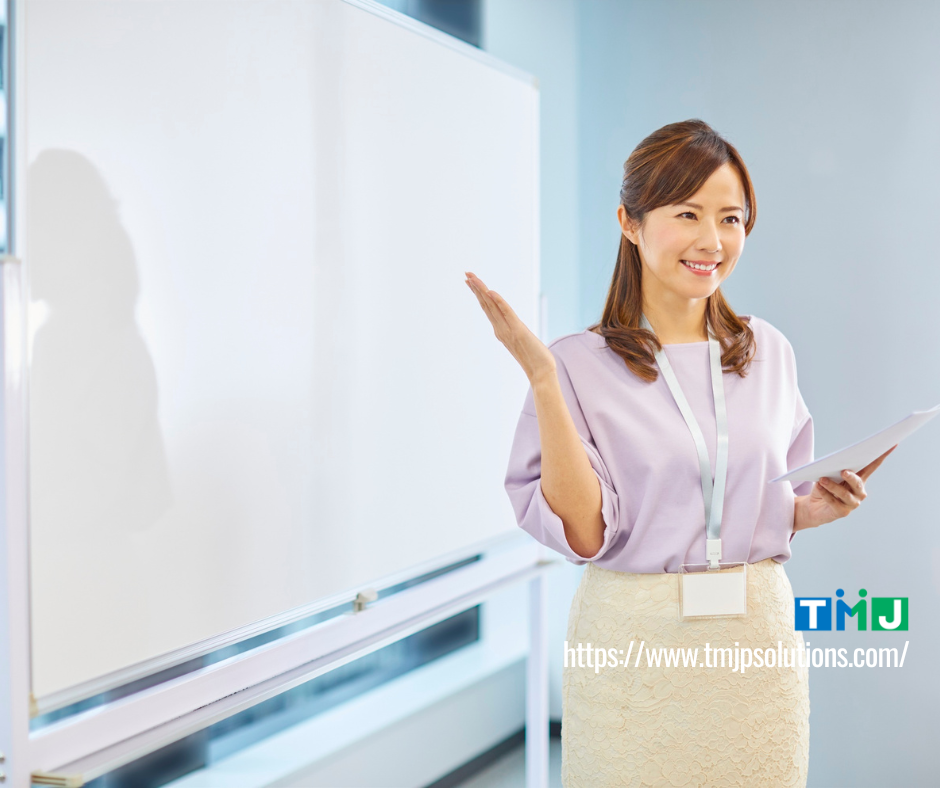 Professional presenting beside a whiteboard with notes in hand, symbolizing BEX Pro’s focus on visible progress and measurable communication results.