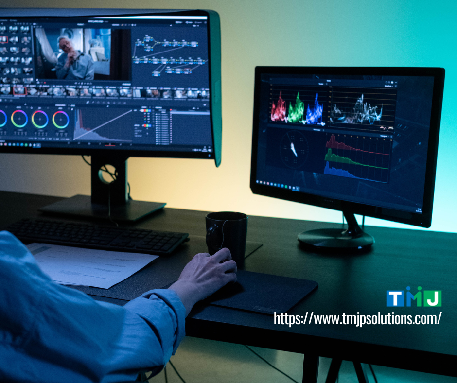 Professional video editing workspace with dual monitors showing color grading and waveform analysis, symbolizing scalable web and application development needs in 2026.
