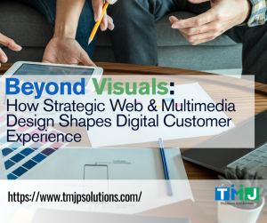 Two people collaborating on web and multimedia design using printed layouts and digital tools.