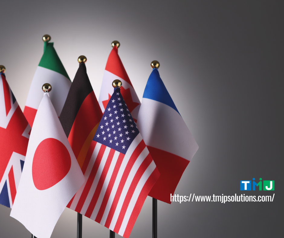 Cluster of seven national flags including UK, Japan, Italy, Germany, Canada, US, and France, symbolizing international relations and global cooperation in 2026.