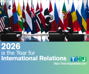 International flags behind conference chairs with text promoting global relations in 2026