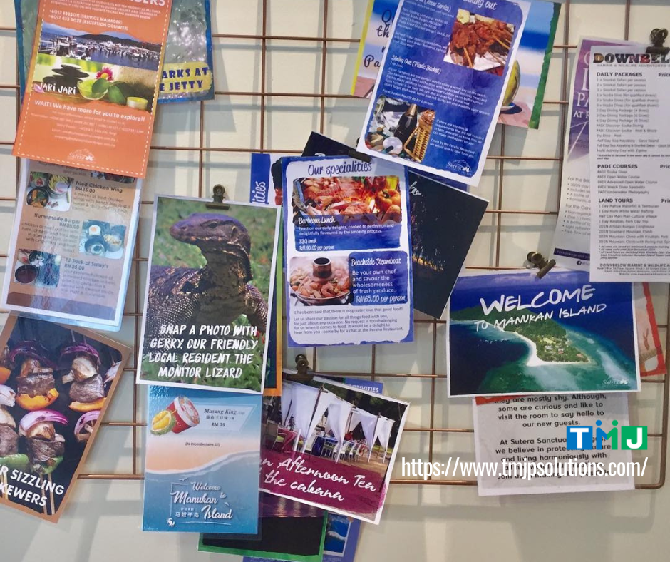 Bulletin board with colorful flyers promoting Manukan Island tourism, symbolizing how global events influence and elevate local business practices.