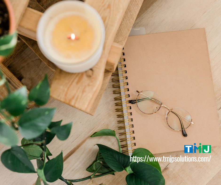 Desk with calming candle and notepad, symbolizing workplace stress relief through soothing scents and task prioritization.