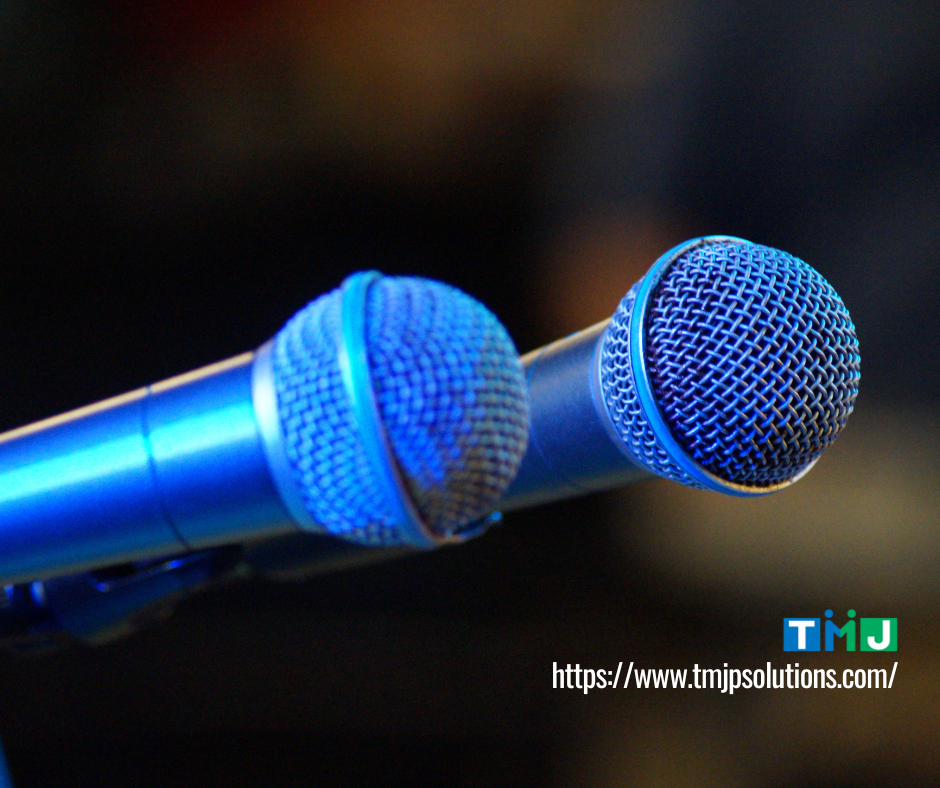 Close-up of microphones arranged together, symbolizing public speaking and addressing an audience.