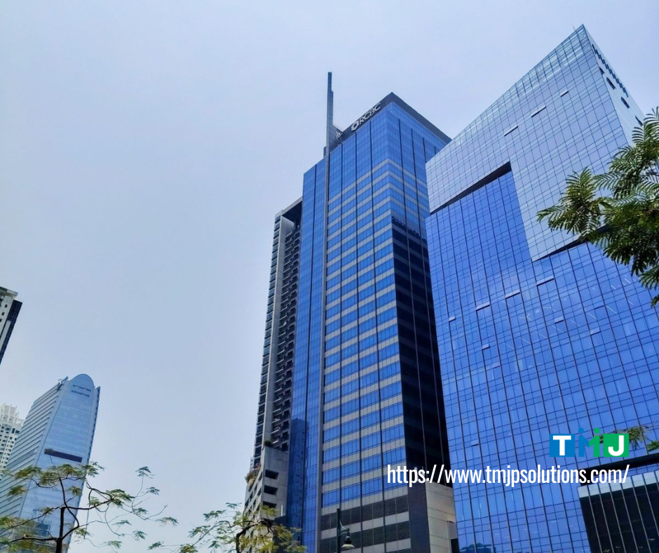 Cluster of modern high-rise office buildings with reflective glass facades in Bonifacio Global City, including the A.T. Yuchengco Centre, where TMJP has been located since 2015.